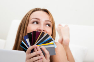 Portrait Of Happy Young Woman Shopping With Credit Card